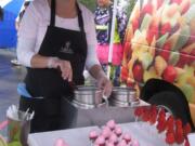 Washougal: Lisa and Chris Schloe of Edible Arrangements dipped strawberries in pink chocolate all night to support the Motocross Race for a Cure.