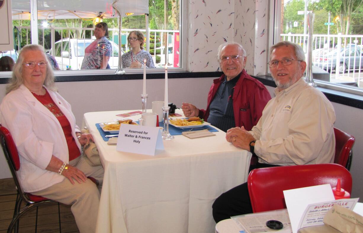 East Minnehaha: Frances and Walter Holy, left, are joined by Burgerville chief culture officer Jack Graves for a party at the Scholls and Allen restaurant in Beaverton, Ore.