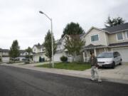 A man walks out of a house on Northeast 139th Court in the Sifton area that was raided by authorities in a drug sting on Thursday.