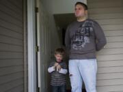 Vlad Pech Sr., 30, reflects on Thursday's drug bust near his house, while his son, Vlad Jr., stands by his side.