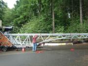 Jeff Peterson fastens the pumpkin cannon's 38-foot barrel to its supporting framework.