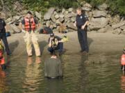 Police, firefighters and paramedics respond to a man standing in the Columbia River near the boat dock adjacent the Red Lion Hotal at the Quay.