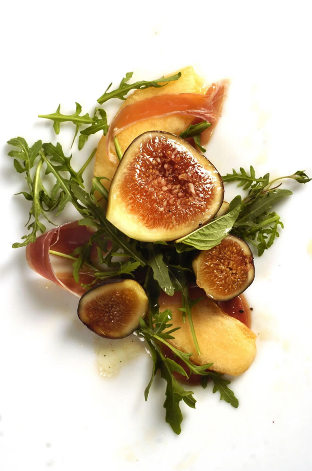 Arugula with heirloom melon slices, ripe figs and prosciutto.