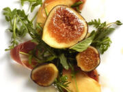 Arugula with heirloom melon slices, ripe figs and prosciutto.