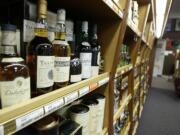 Bottles of scotch sit on a shelf at a state liquor store in Tumwater.