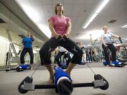 Jill Olafson, 41, works out with other Nautilus employees to familiarize themselves with the company's first new fitness product in several years: the CoreBody Reformer.