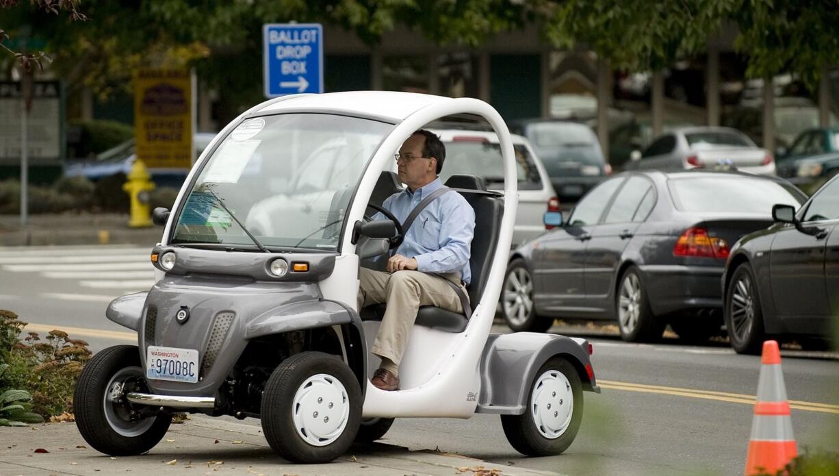 Vancouver City Councilor Jack Burkman test drives the GEM, or Global Electric Motorcars, eS Electric Thursday during an electric vehicle fair at the Clark County Public Service Center plaza in downtown Vancouver.