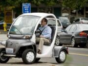 Vancouver City Councilor Jack Burkman test drives the GEM, or Global Electric Motorcars, eS Electric Thursday during an electric vehicle fair at the Clark County Public Service Center plaza in downtown Vancouver.