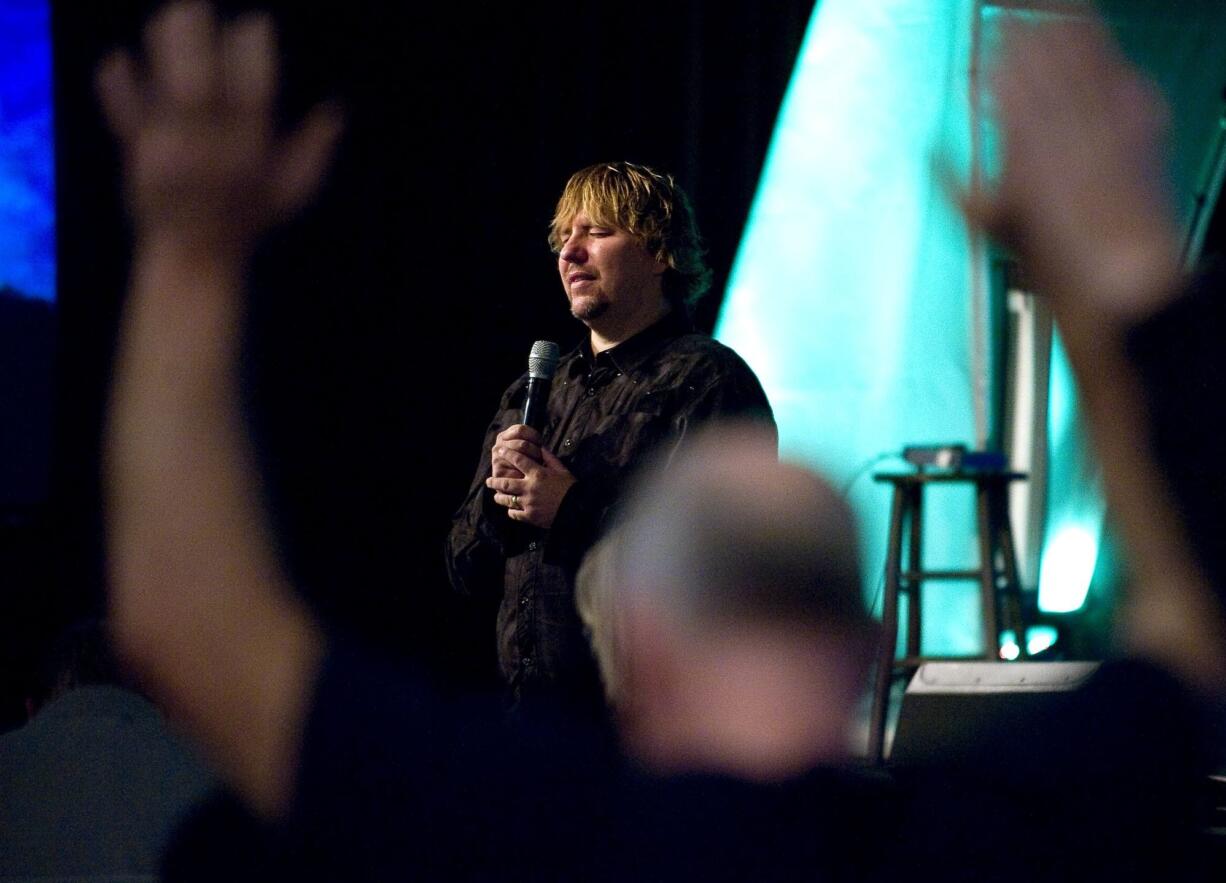 The Rev. John Bishop leads prayer during a staff meeting at the former Kmart store on Andresen Road -- now the new home of Living Hope Church.