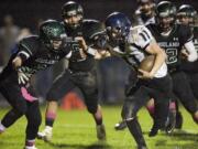 Hockinson's Josiah Niemela (11) rushed for 203 yards and three touchdowns in the victory at Woodland, including one on this play.