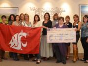 Cathy Anna Mayer Encouraging Others members received a Campaign for Washington State University flag as thanks for their support of the At Home At School program at WSU Vancouver.