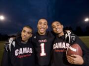 Jonathan Warner, center, poses with his autistic twin brothers, Christian, left, and Austin, at Camas High School.