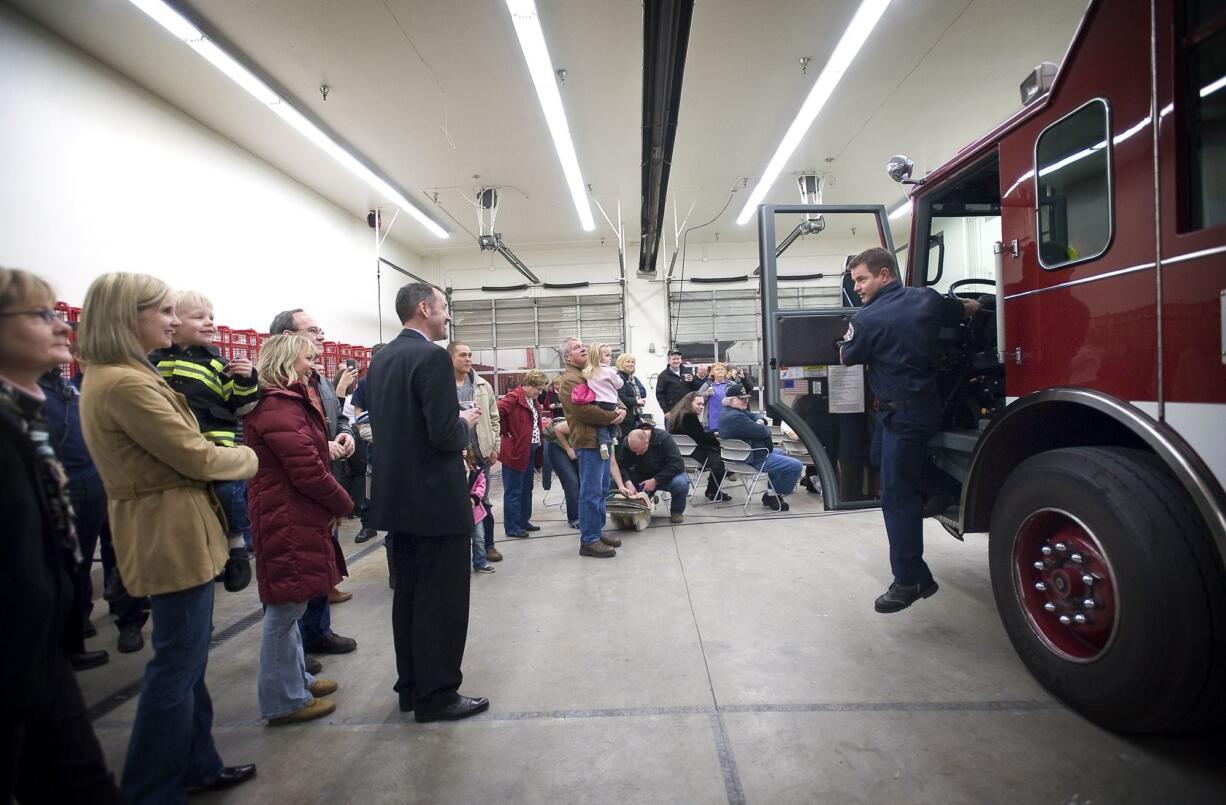 Vancouver Firefighter Carl Svendsen steps out of Fire Engine 6 after pulling inside the Station 6 during a reopening ceremony on Sunday evening.