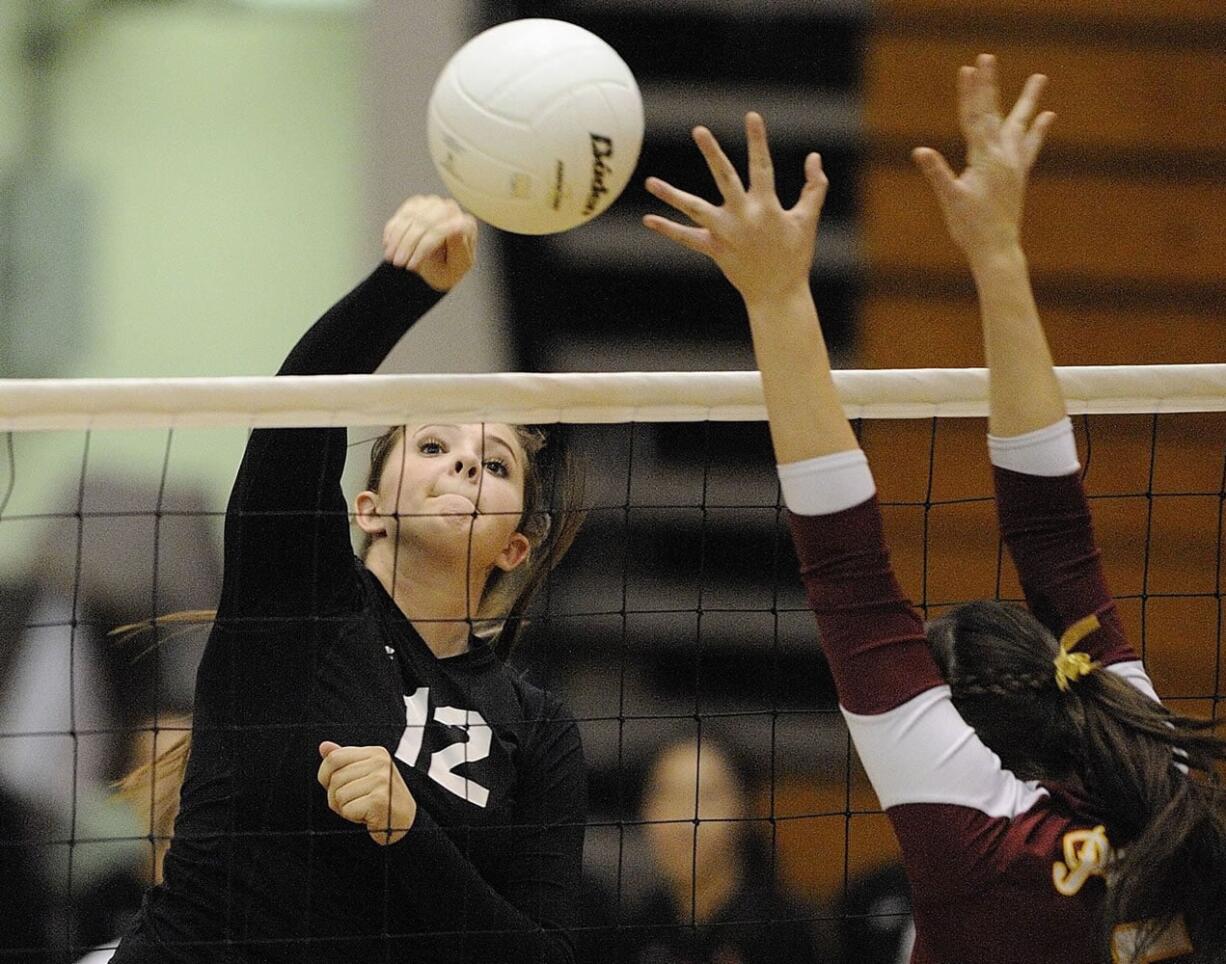 Sydney Schwartz of Camas hits against Prairie's Carissa Campbell in the district title match.