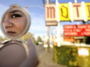 &quot;Jennifer,&quot; a Clark County teen formerly involved in prostitution, watches over Portland's Southeast 82nd Avenue.