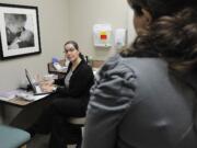 Dr. Karen Rosenblum listens to patient Yudmila Kononenko during a routine pregnancy examination at The Vancouver Clinic last week.