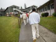 Inmates at the Larch Corrections Center walk back to the barracks earlier this year.