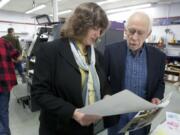 Susan Tissot, executive director of the Clark County Historical Museum, and Howard Gingold, editor of the annual &quot;Clark County History&quot; journal, watch covers roll off the press at Columbia Litho Printing and Imaging in Camas.