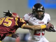 Camas' Zack Marshall (25), fighting off O'Dea's Tyler Longmire, rushed for 51 yards on six carries in the first quarter before leaving with a dislocated thumb.