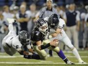 Skyview defenders Xavier Norman (5) and Hayden Shuh (9) sack Lake Stevens quarterback Jake Nelson during Saturday's Class 4A state semifinal at the Tacoma Dome.