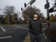 James Bray stands at the corner where he rescued the driver of a burning car that hit a utility pole at 2 a.m. Saturday.