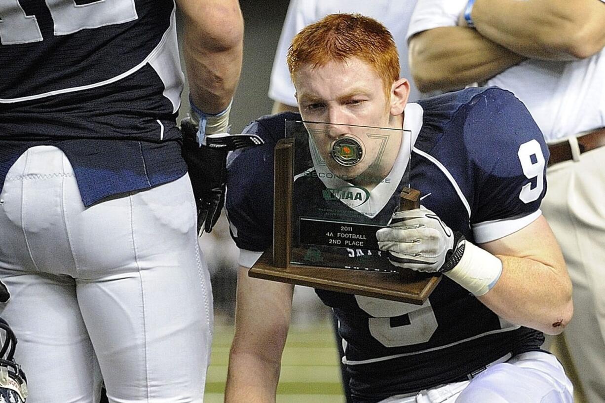 Skyview's Hayden Shuh kisses the second-place trophy during Saturday's award ceremony following the Storm's  loss to Skyline in the Class 4A state championship game.