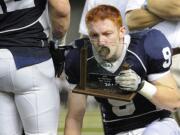 Skyview's Hayden Shuh kisses the second-place trophy during Saturday's award ceremony following the Storm's  loss to Skyline in the Class 4A state championship game.