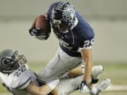 Skyline's Connor Gilchrist (22) makes a tackle on Skyview's Mo Morrison (25) during the first half of Saturday's 4A championship game at the Tacoma Dome.