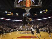 Elliot Williams dunks the ball during warm-ups before a scrimmage during Blazer Fan Fest at The Rose Garden on Friday.