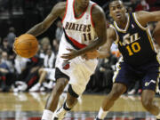 Jamal Crawford (11) drives past Utah's Alec Burks. Crawford scored eight points in his first game in Portland as the Blazers won the preseason game 110-90 on Monday.