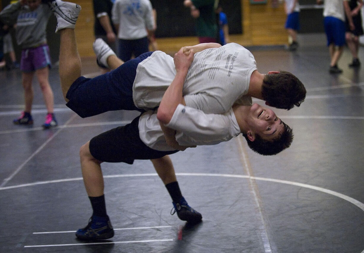 Patrick Mayolo, bottom, takes down teammate Dustin Veysey during practice Tuesday.