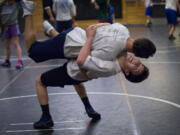 Patrick Mayolo, bottom, takes down teammate Dustin Veysey during practice Tuesday.