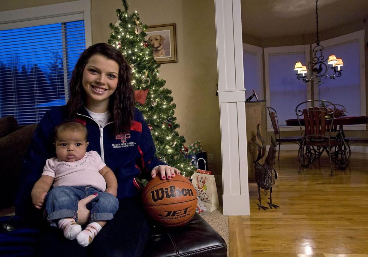 Skyview High School graduate and Saint Mary's College basketball player Ashlee Smith poses with her 11-week-old daughter Addison Harris at her family's Felida home.