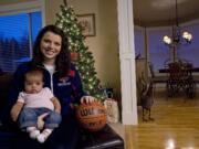 Skyview High School graduate and Saint Mary's College basketball player Ashlee Smith poses with her 11-week-old daughter Addison Harris at her family's Felida home.