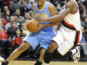 Denver Nuggets' Andre Miller (24) drives against Portland Trail Blazers' Wesley Matthews (2) during the first half of an NBA basketball game in Portland, Ore., Thursday, Dec 29, 2011.