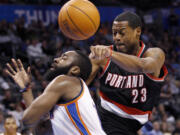 James Harden, left, loses the ball as he drives to the basket in front of Portland's Marcus Camby (23) in the Blazers' 103-93 win.