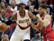 Portland Trail Blazers forward LaMarcus Aldridge, left, tries to move to the basket against Los Angeles Clippers forward Blake Griffin during the first quarter of their NBA basketball game in Portland, Ore., Tuesday, Jan.