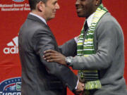 Commissioner Dan Garber, left, welcomes Andrew Jean-Baptiste, the eighth player drafted in the first round by the Portland Timbers during Thursday's MLS SuperDraft in Kansas City, Mo.