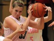 Mountain View defenders swarm Camas post Jenka Stiasna (33) during Friday's game, which was Camas' annual Hoops for Pink cancer awareness night.