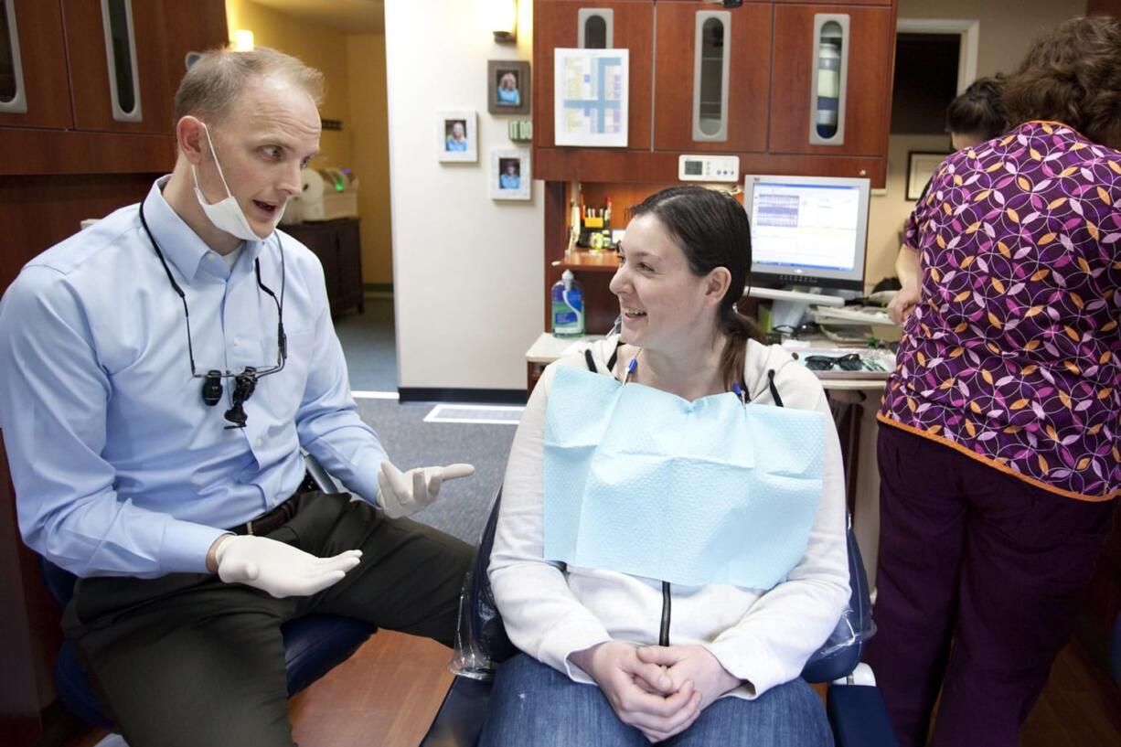 Vancouver resident Kendra Reagan, 23, listens as Dr. Dave Stinchfield explains his treatment plan.