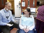 Vancouver resident Kendra Reagan, 23, listens as Dr. Dave Stinchfield explains his treatment plan.