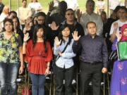 From left to right, Mervat William, Charmaine Balangue, Anh Thy Le, Oscar Hernandez Juarez and Aylesha Choudhury, take the oath of allegiance at a Naturalization Ceremony Friday in Vancouver.