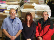 Battle Ground: Instead of recycling  them, Glenn Haag, left, Kathy Berecek and Bill Olson of the Battle Ground public schools warehouse sent 35,800 pounds of surplus math materials to needy schools in Ghana, West Africa.