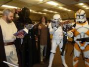 Fishers Landing: Jedi Librarian Paul Warner, center, gives a thumbs up to avid &quot;Star Wars&quot; readers Jedi Master Rick Thomas; Darth Vader (David Acheson); Stormtrooper Calvin Smith and Clonetrooper Scott Thingelstad.