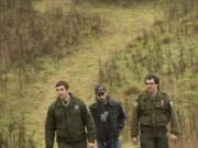 Park Ranger Mark Shaw, from left, intern Shawn Herrmann and Park Manager Matt Smith walk on a new trail at Paradise Point State Park earlier this month.