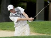 Landon Banks chips out of the bunker to the 12th green at Royal Oaks Country Club.