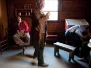 Actors Frank van Waardenburg, center, and Bullie Magsayo, left, enjoy a lighter moment between takes while filming a church scene at Fort Vancouver.