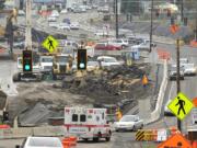 Motorists on Monday make their way through a rearranged intersection at St. Johns Boulevard and state Highway 500, where construction has temporarily eliminated all turns from the highway to St. Johns. Crews are transforming the intersection into a freeway-style interchange, which will send St. Johns up and over the highway on a new bridge.