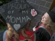 Cori Jones' mortarboard makes it clear how she feels  about her mother, Cheryl, right. Both women graduated Saturday from Washington State University Vancouver.