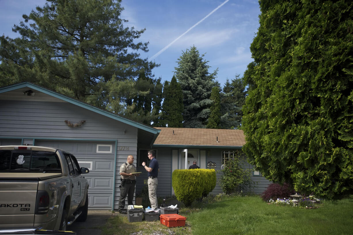 Police investigate a homicide at a home on Northeast 76th Street on Wednesday.